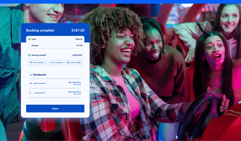 A group of young people playing an arcade game at an FEC