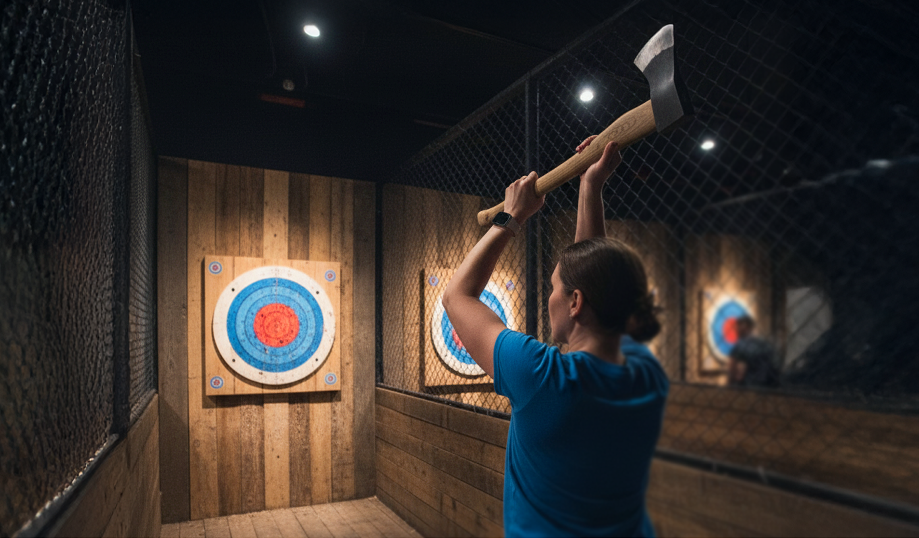 A woman throwing an axe at a target in an axe throwing venue